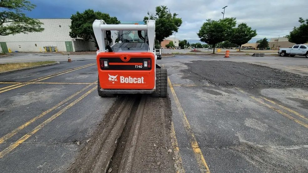 Bobcat compact track loader on a paved road on a Rochester NY job