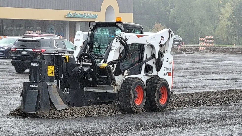 Skid-steer loader leveling a gravel lot — Piranha Rents, Rochester NY