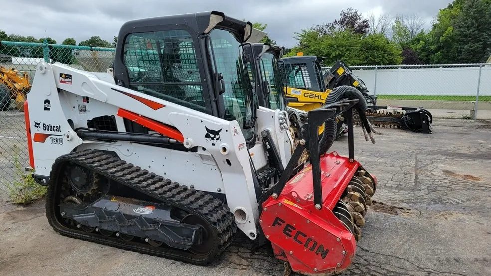 Track loader running a forestry mulcher — Piranha Rents, Rochester NY