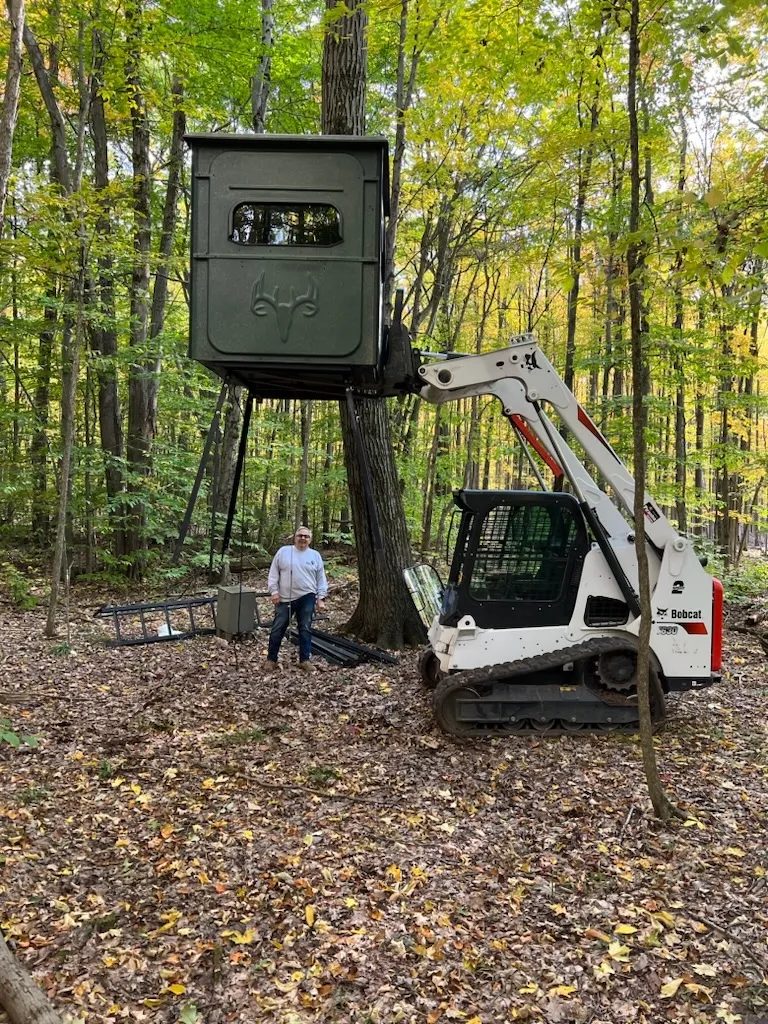 Setting an elevated deer stand in the woods — Piranha Rents, Rochester NY